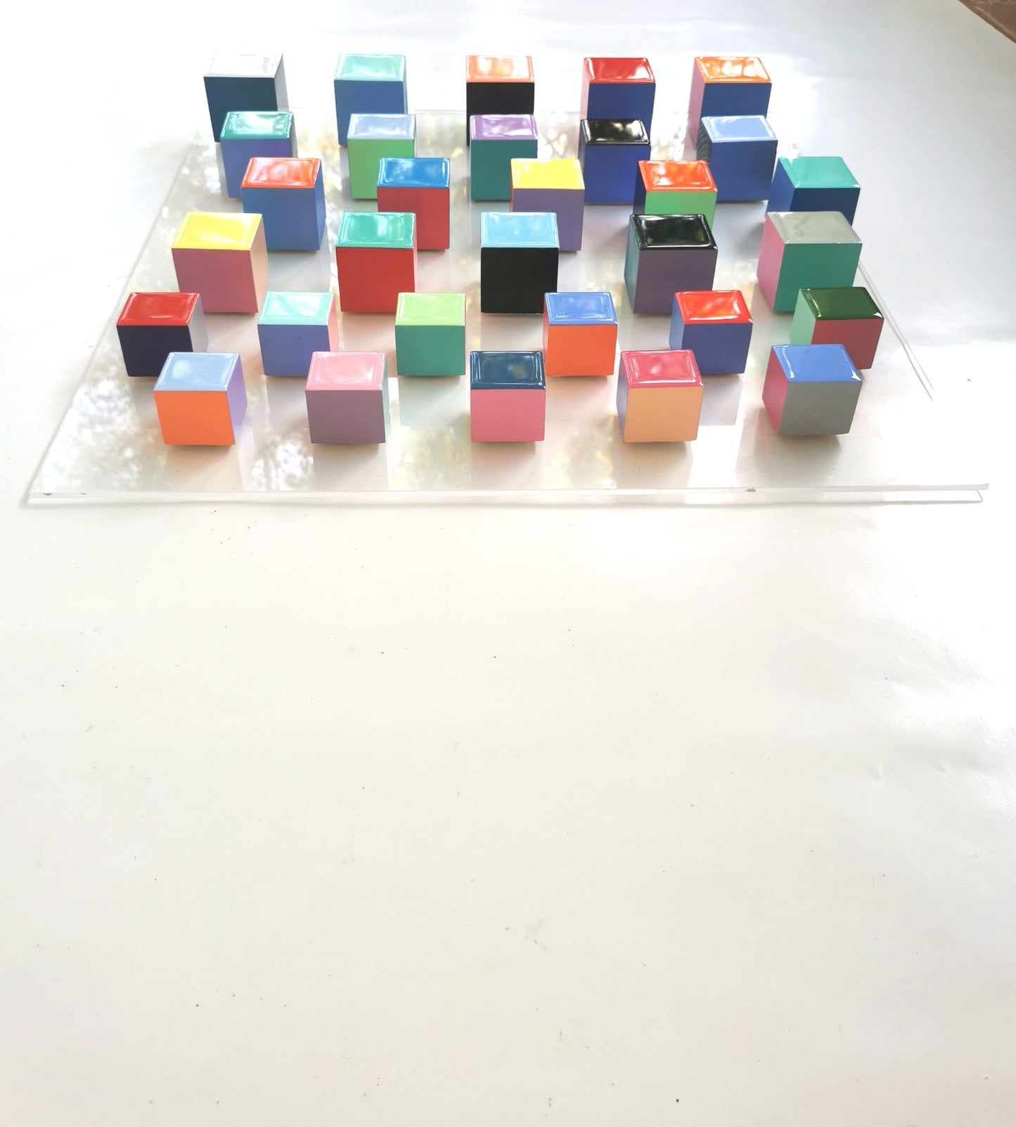 Wood wall art, modern 3d artwork. Sculpture wall art with resin finish on top face. Happy and colorful wood cubes. Acrylic glass base. ©