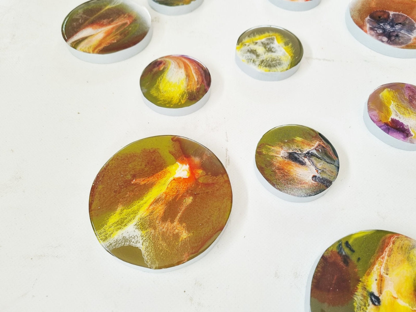 3d installation, hand painted circles with resin on top face. Each circle is a unique work of art. Glossy and shiny ©