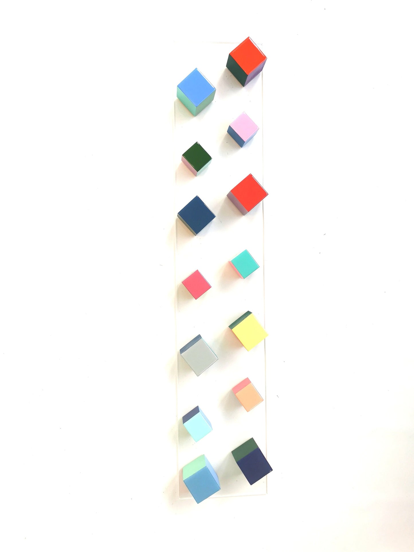 Narrow and long wood wall art. Geometric and colorful wood cubes. Happy colors. Modern 3D art. Wooden wall art with resin on the top face ©