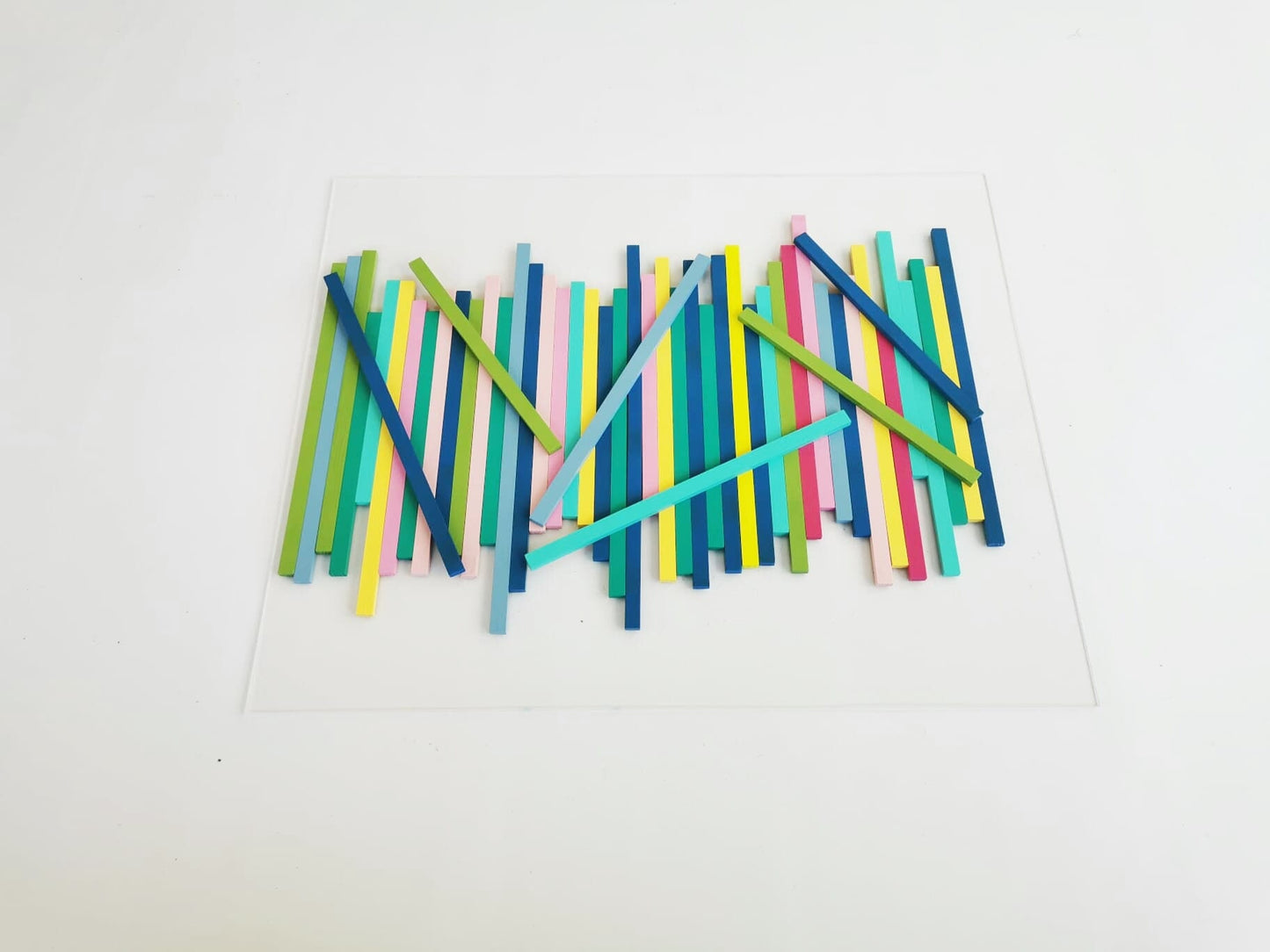 Large wood wall art in happy colors. Made from hand-painted wooden slats, mounted on a transparent acrylic glass base. Modern sculpture.©