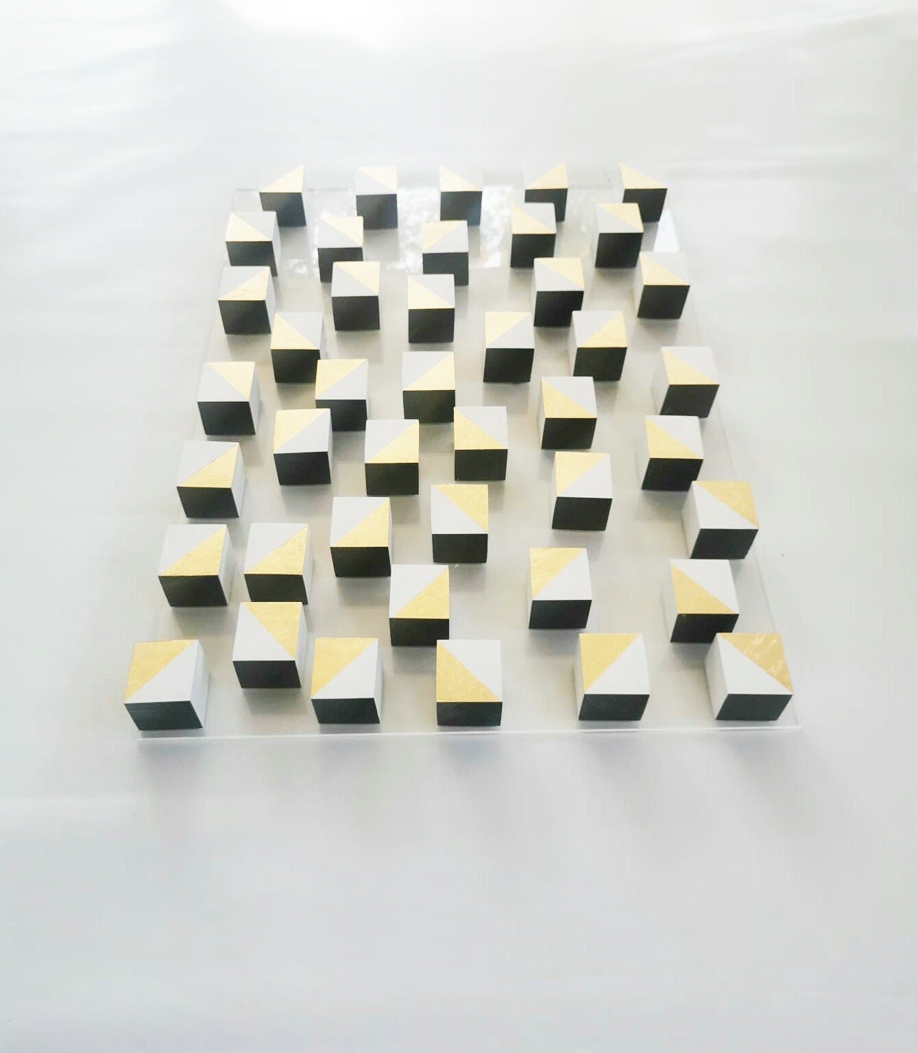 White and gold wood wall art. 3D art. Modern and geometric wall decor. Gold leaf, Home decoration and 3d installation. Sculpture wooden art