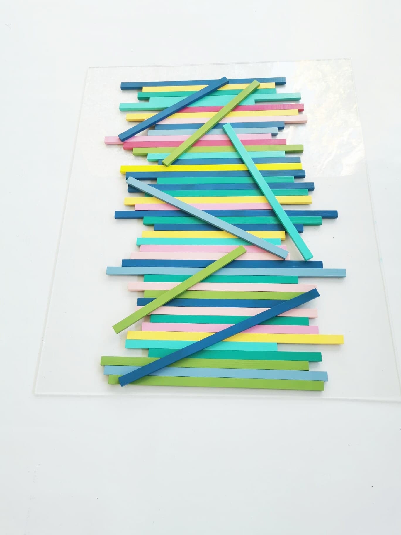 Large wood wall art in happy colors. Made from hand-painted wooden slats, mounted on a transparent acrylic glass base. Modern sculpture.©