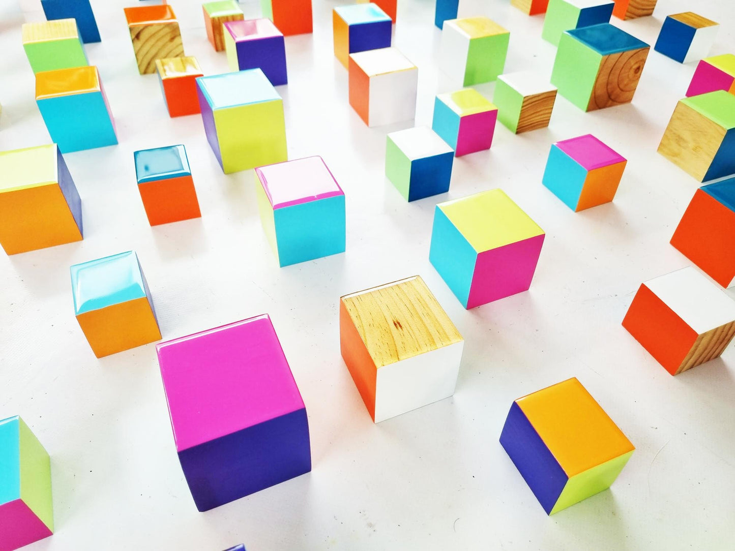 3d installation, Colored cubes with resin finish on top. Set of colorful blocks with some sides in natural wood. Modern sculpture 3d.